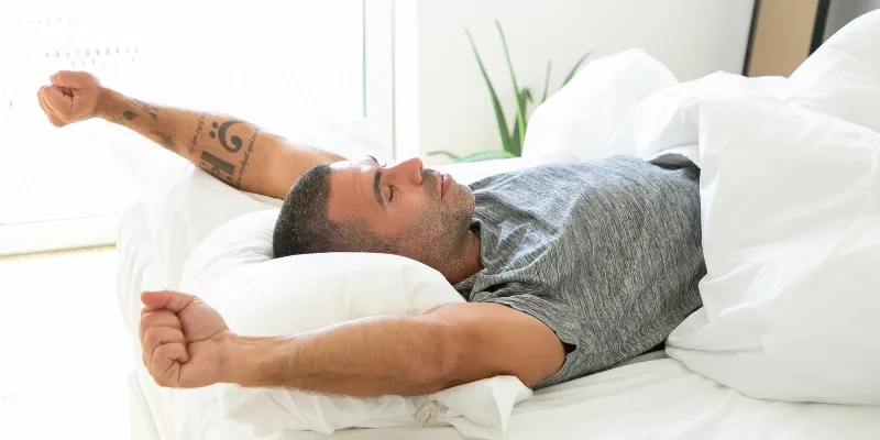 Man waking up refreshed.